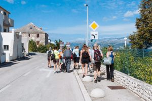 Our cycling group walking into Postira.