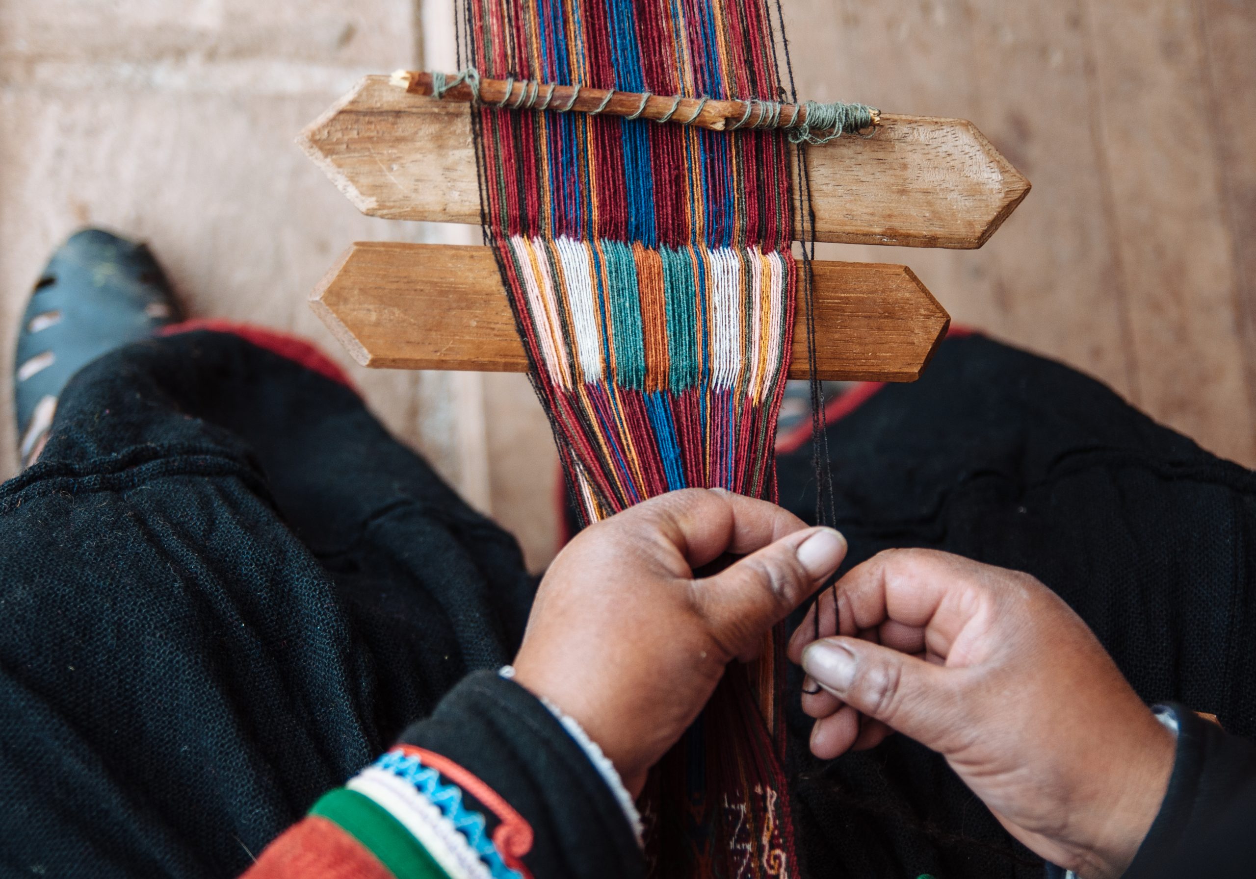 A woman at the Chinchero Weaving Collective creating a meticulous pattern