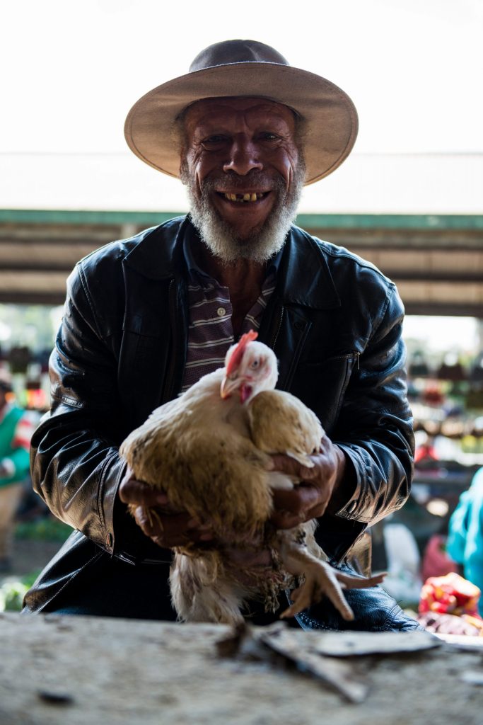 Papua New Guineans are often quick with a smile – and a chicken.