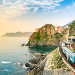 Manarola, Cinque Terre – train station in famous village with colorful houses on cliff over sea in Cinque Terre